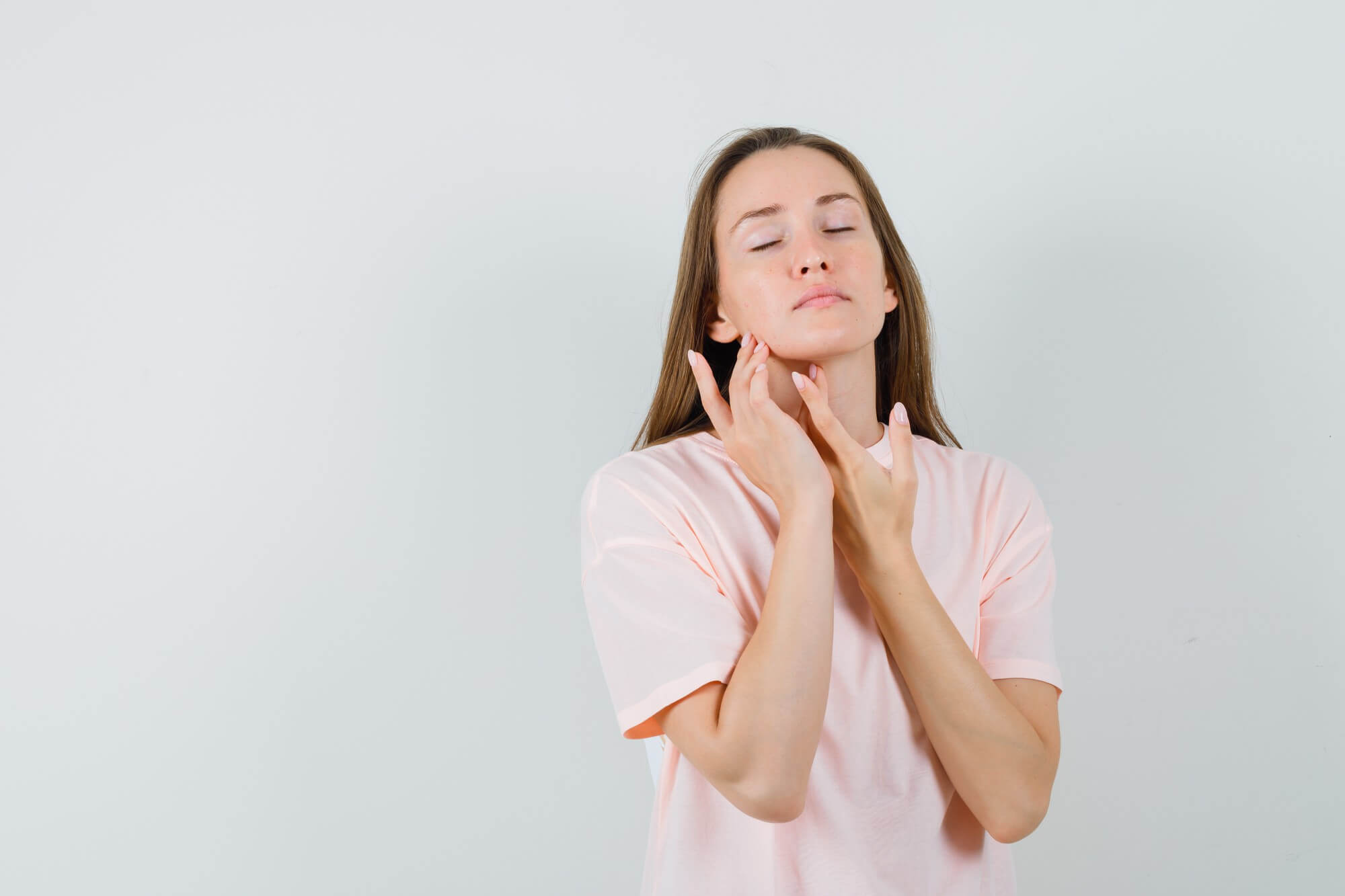 woman feeling her neck